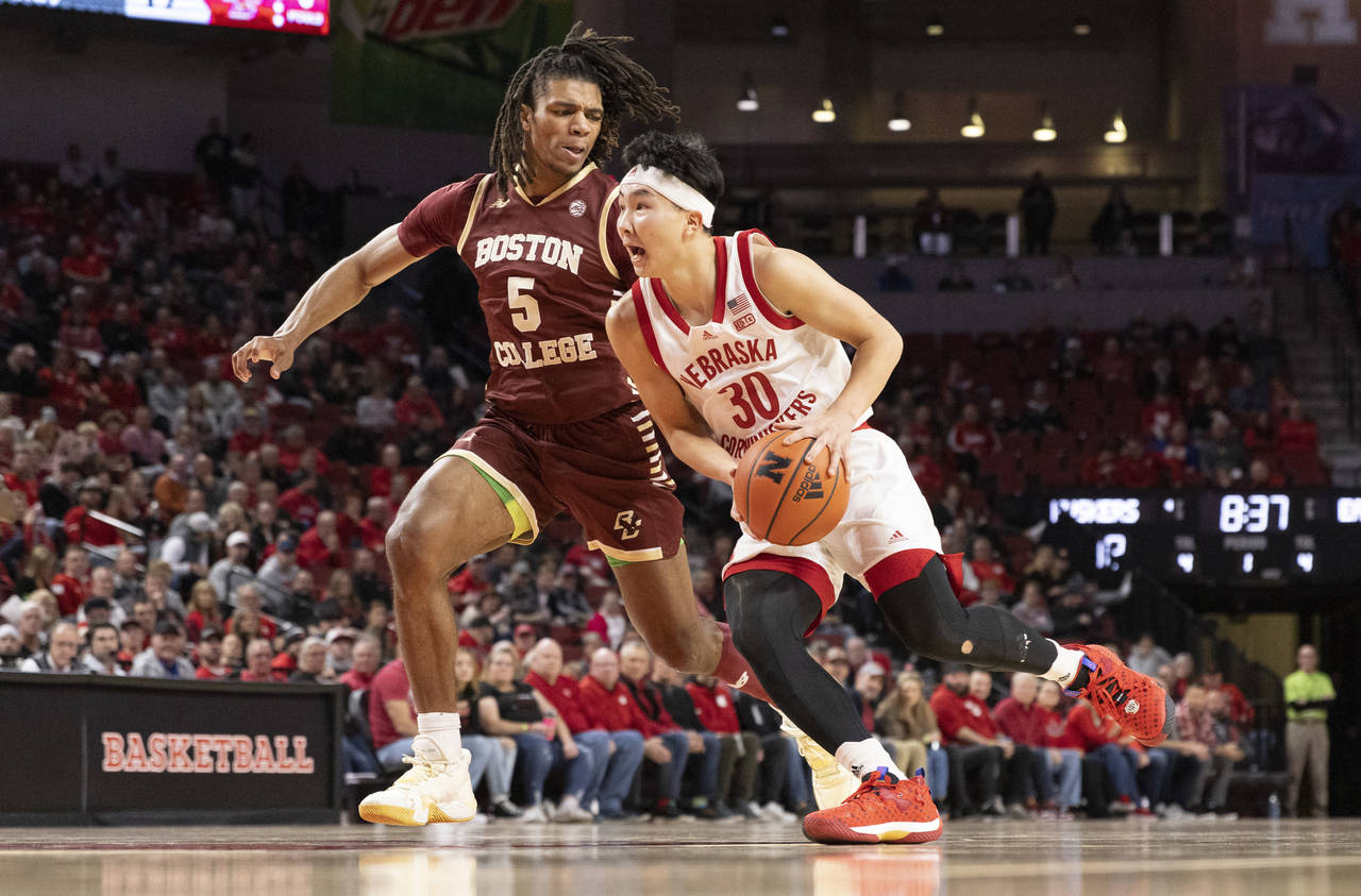 Nebraska's Keisei Tominaga (30) drives against Boston College's DeMarr Langford Jr. (5) during the ...