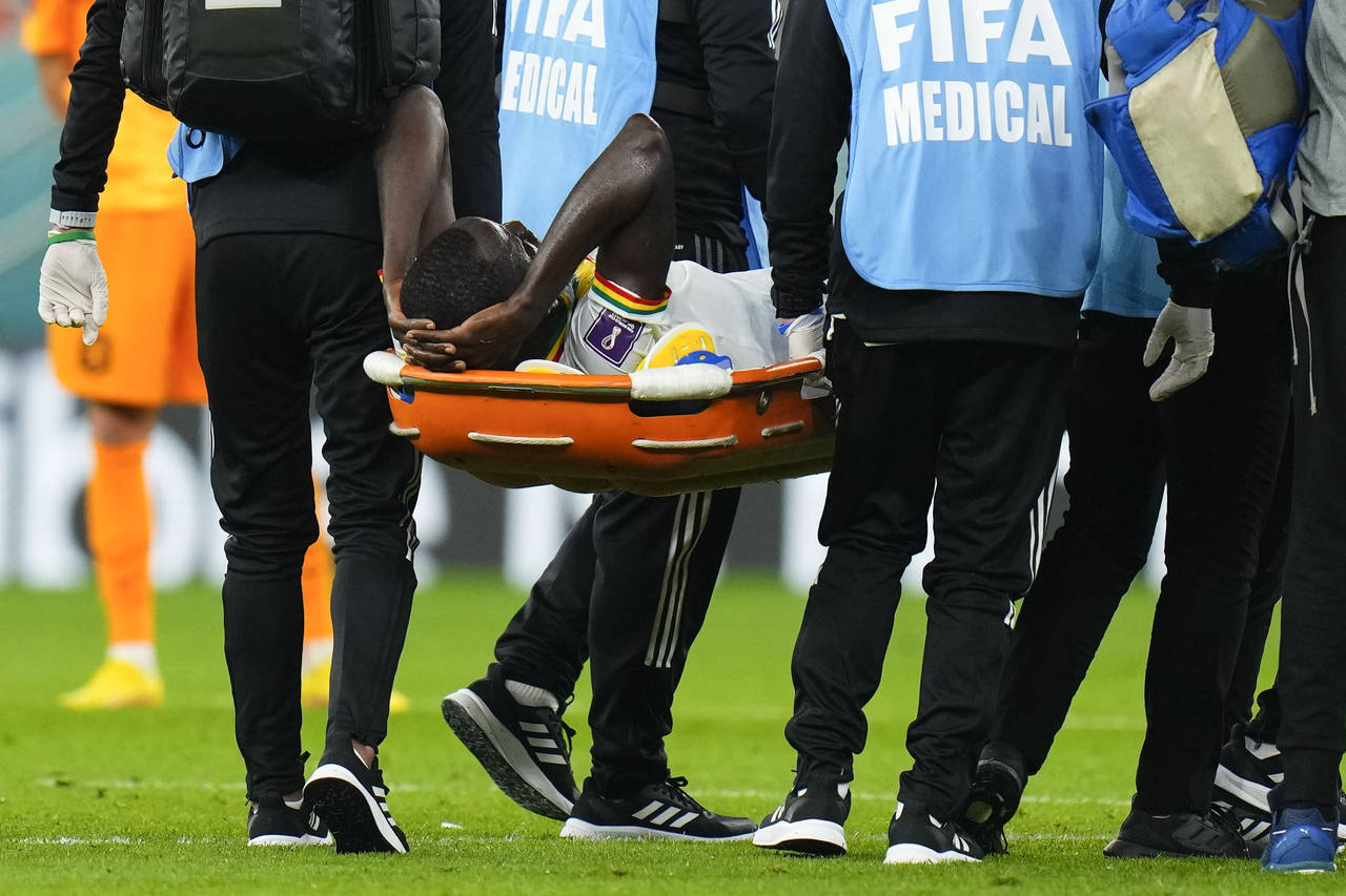 Senegal's Cheikhou Kouyate is taken from the field on a stretcher during the World Cup, group A soc...
