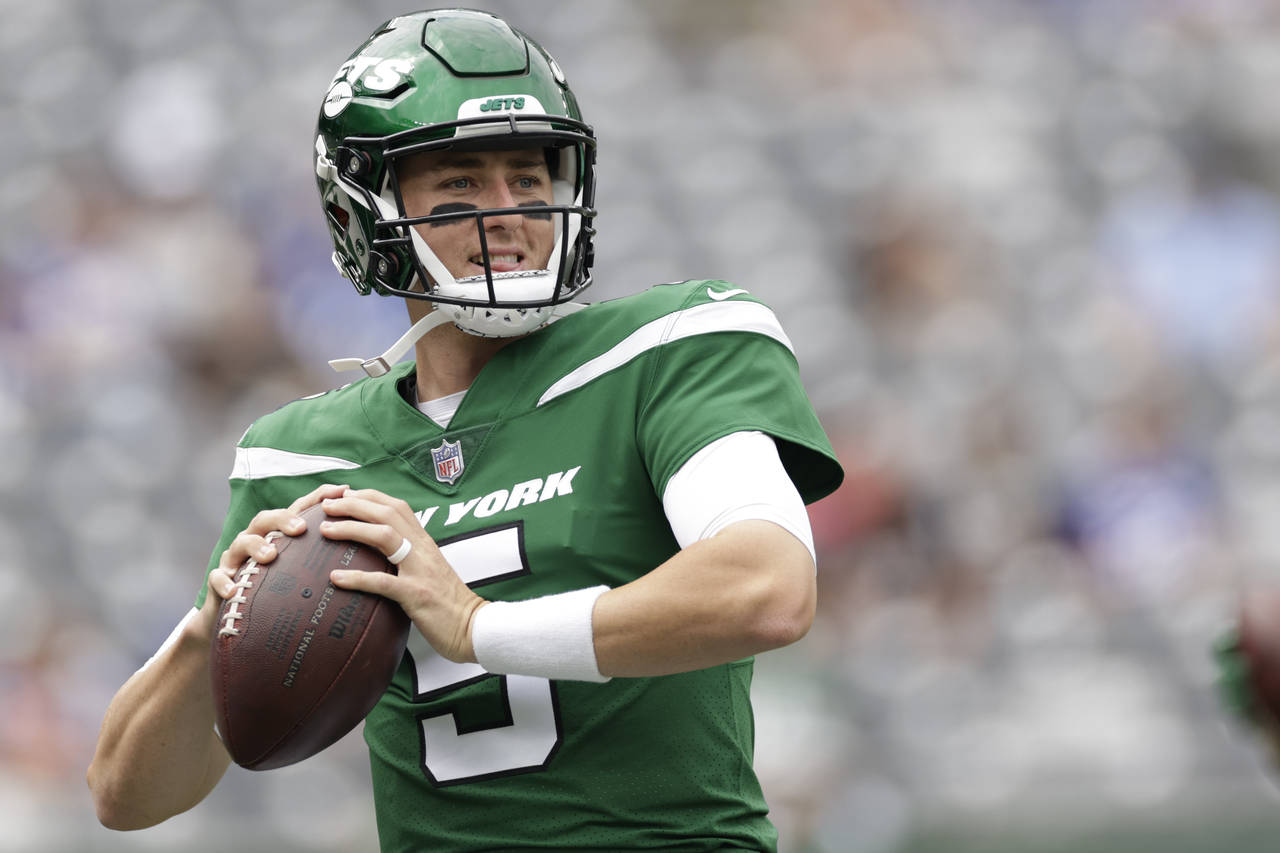 FILE - New York Jets quarterback Mike White (5) practices before a preseason NFL football game agai...