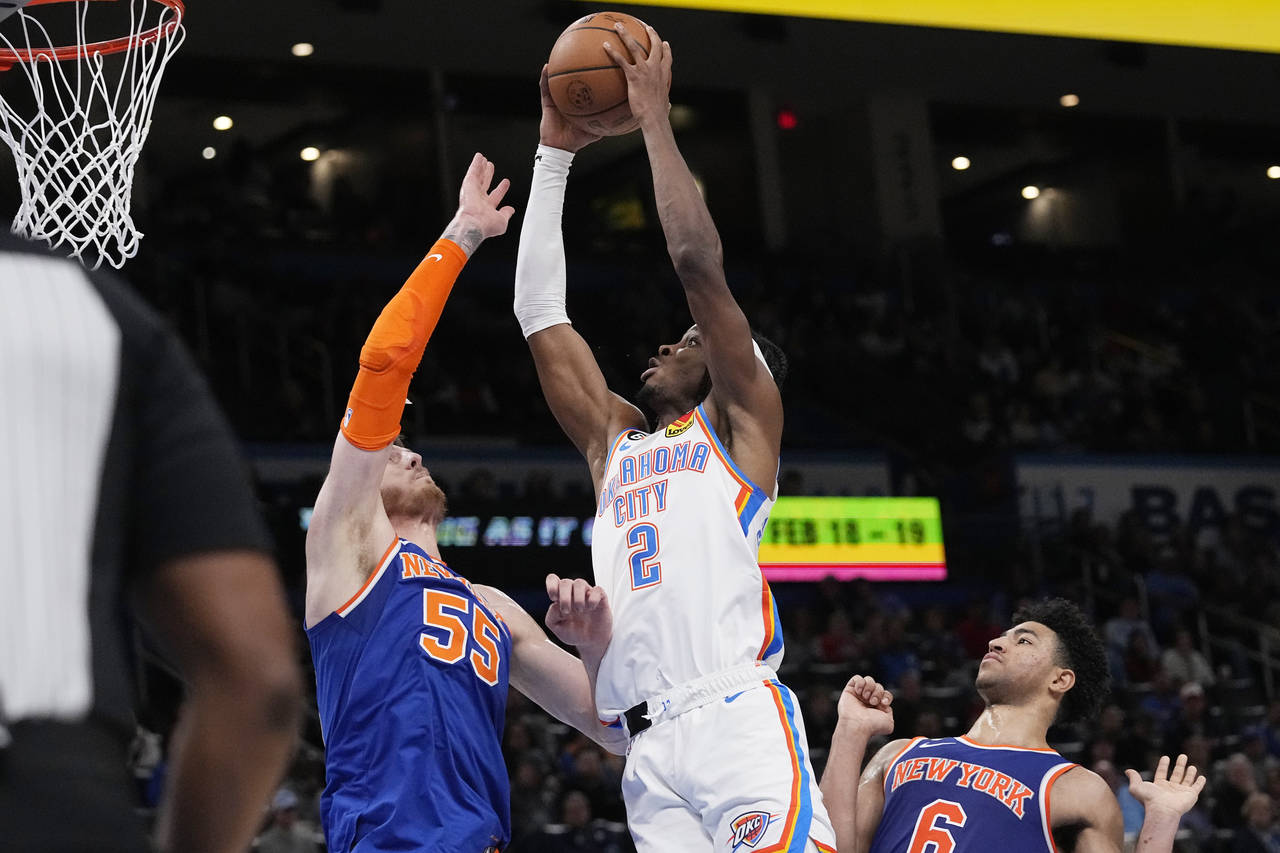Oklahoma City Thunder guard Shai Gilgeous-Alexander (2) goes up to shoot between New York Knicks ce...