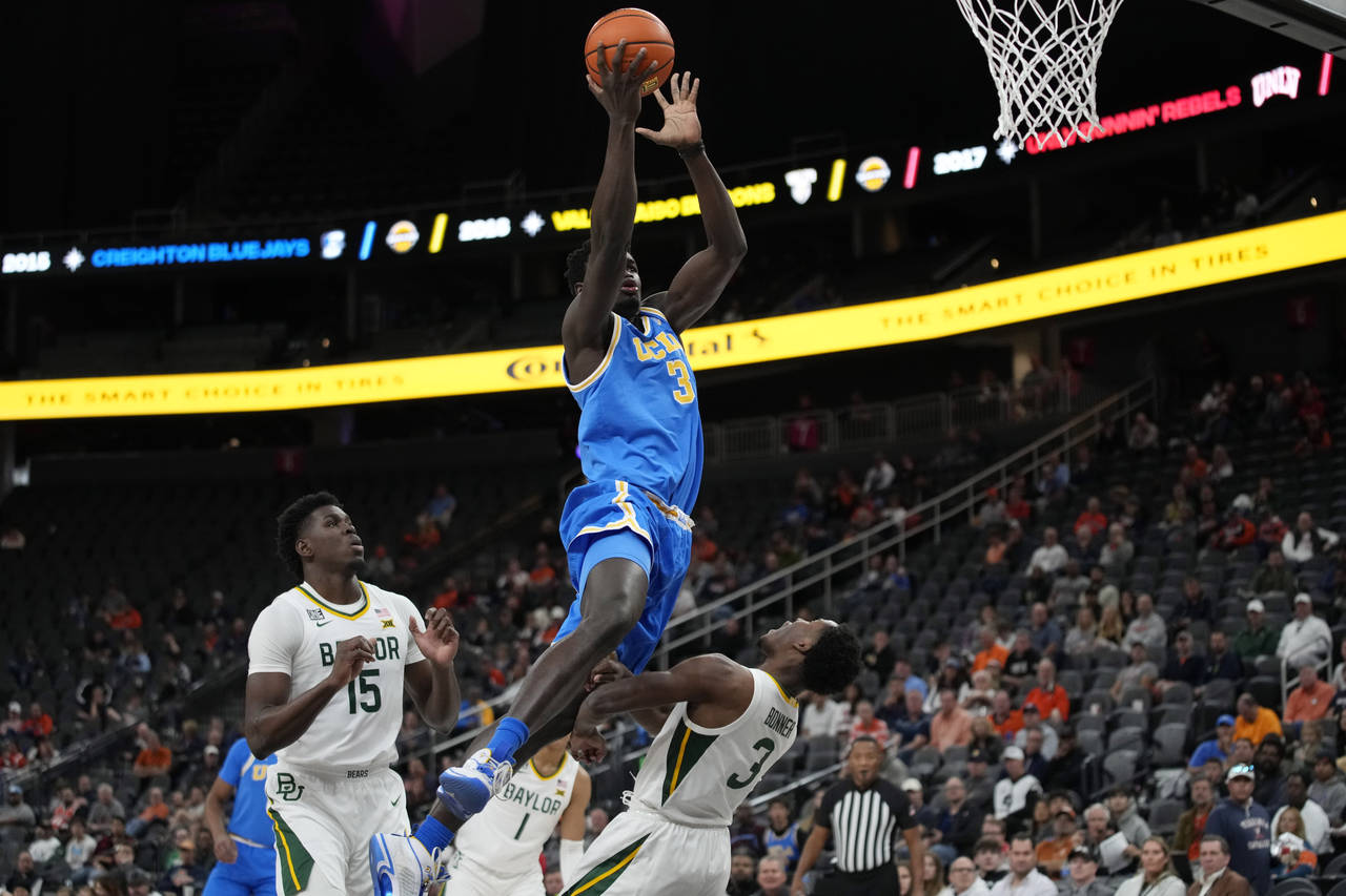 UCLA's Adem Bona, left, fouls Baylor's Dale Bonner during the first half of an NCAA college basketb...