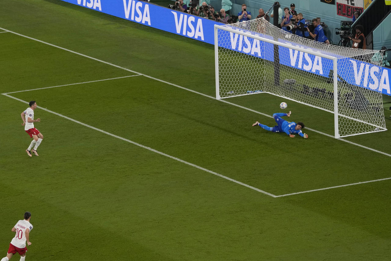 Mexico's goalkeeper Guillermo Ochoa saves on a penalty kick by Poland's Robert Lewandowski during t...