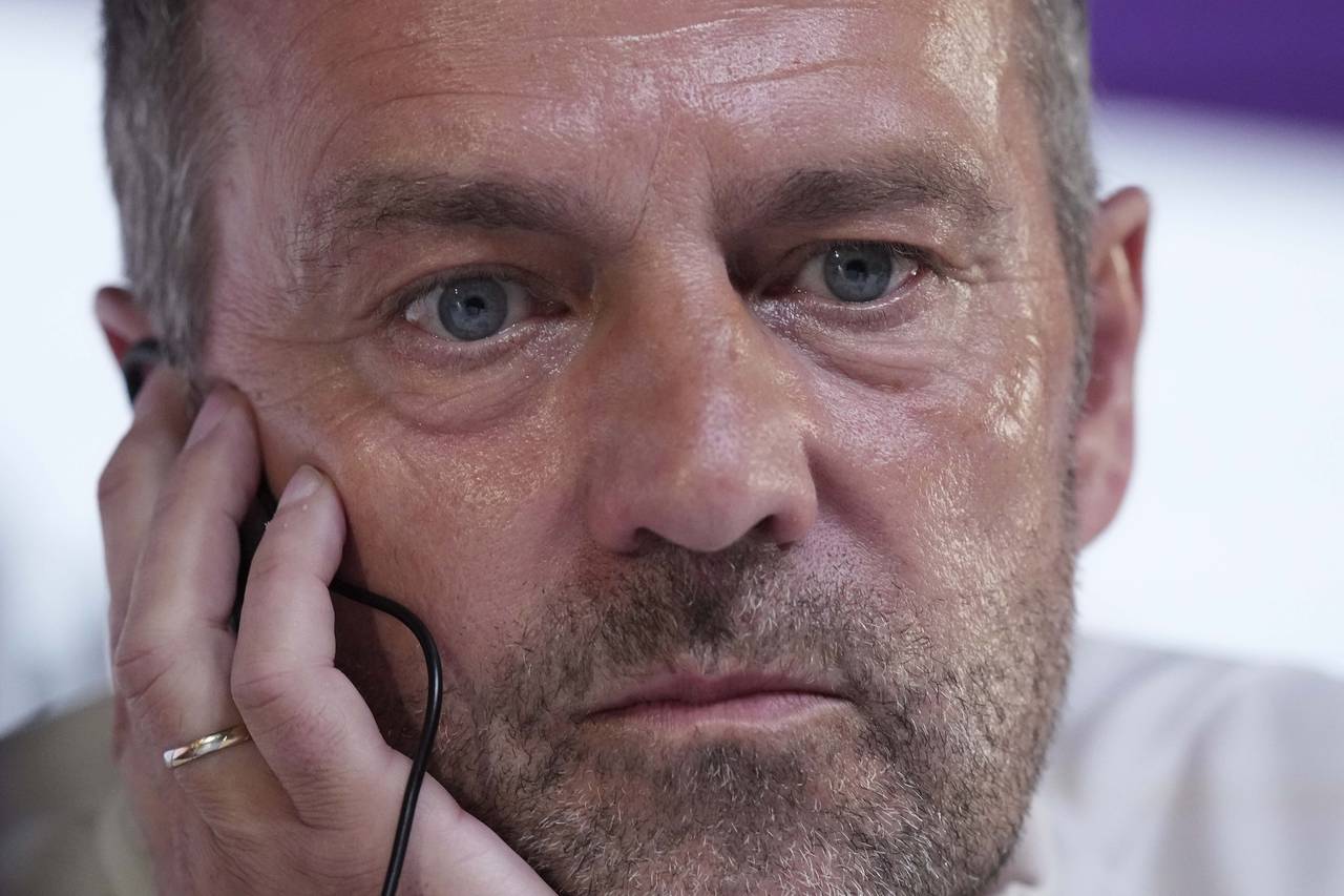 Germany's head coach Hansi Flick listens to questions during a news conference on the eve of the gr...