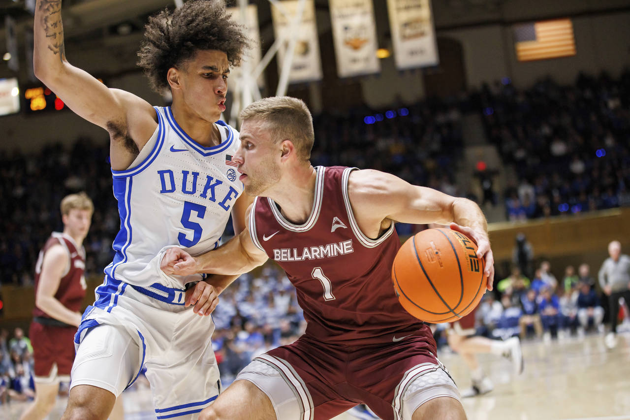 Bellarmine's Juston Betz (1) handles the ball as Duke's Tyrese Proctor (5) defends during the first...