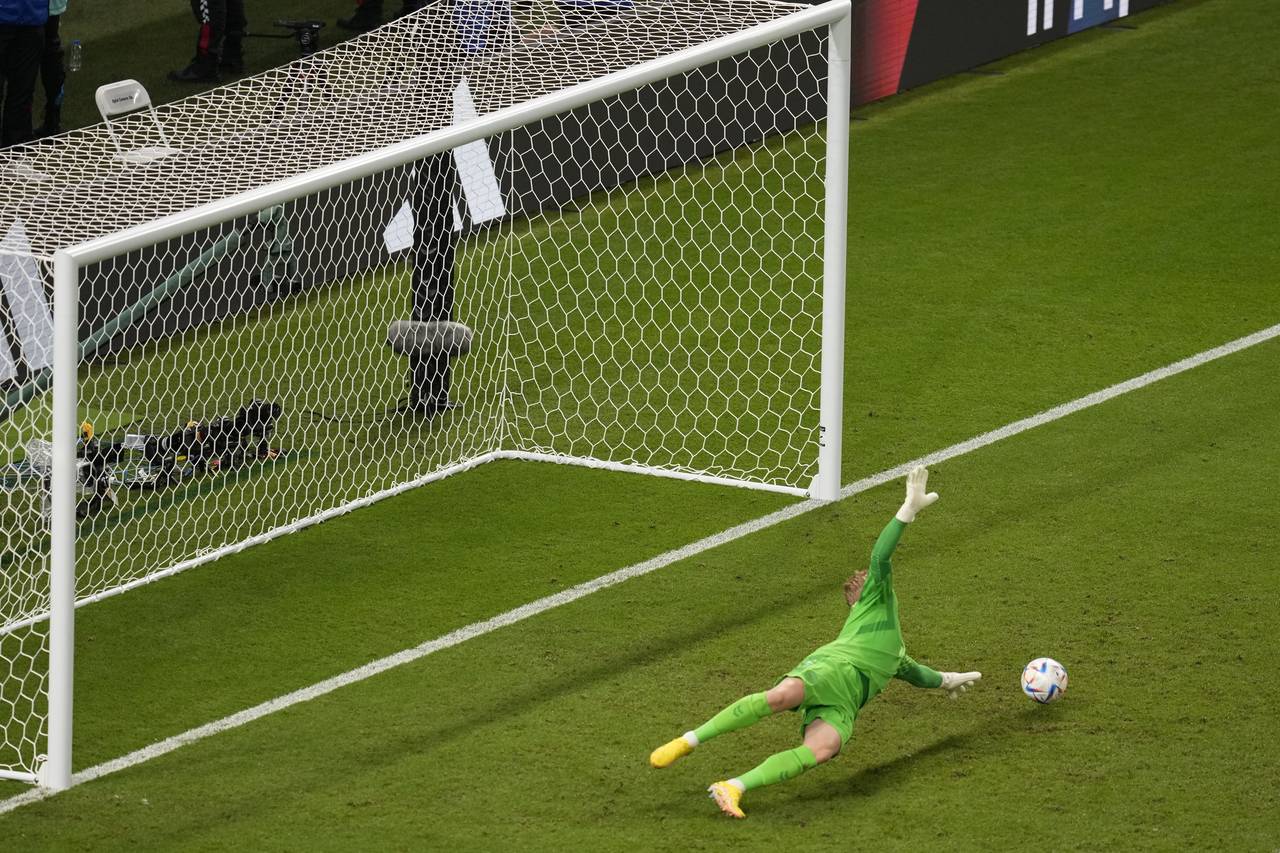 Denmark's goalkeeper Kasper Schmeichel fails to block a shot by Australia's Mathew Leckie, unseen, ...
