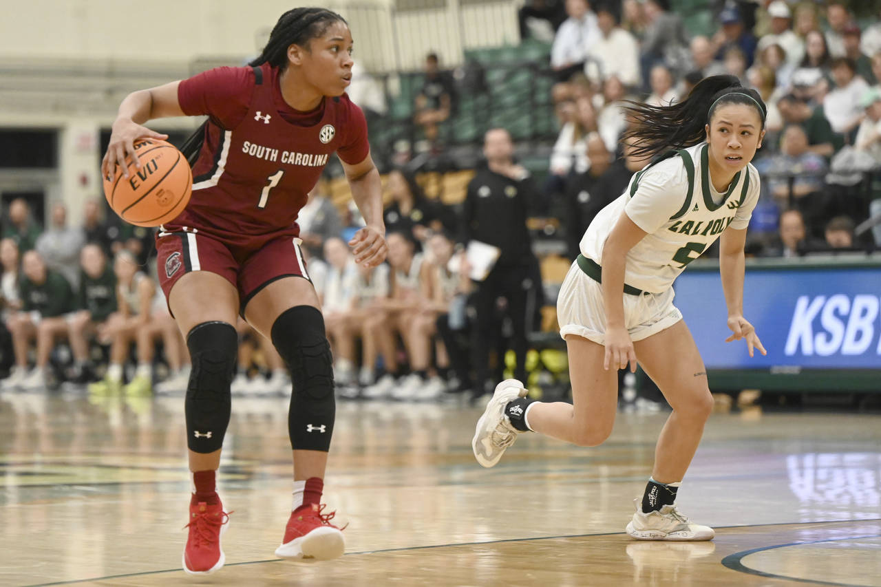 South Carolina guard Zia Cooke (1) dribbles down the court as Cal Poly guard Jazzy Anousinh watches...