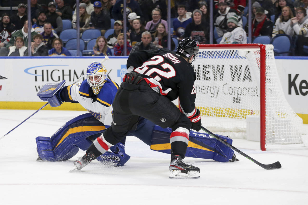 Buffalo Sabres right wing Jack Quinn (22) prepares to score around St. Louis Blues goaltender Jorda...