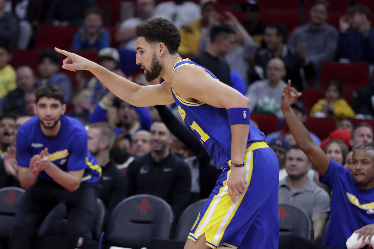 Golden State Warriors guard Klay Thompson reacts after making a 3-point basket against the Houston ...