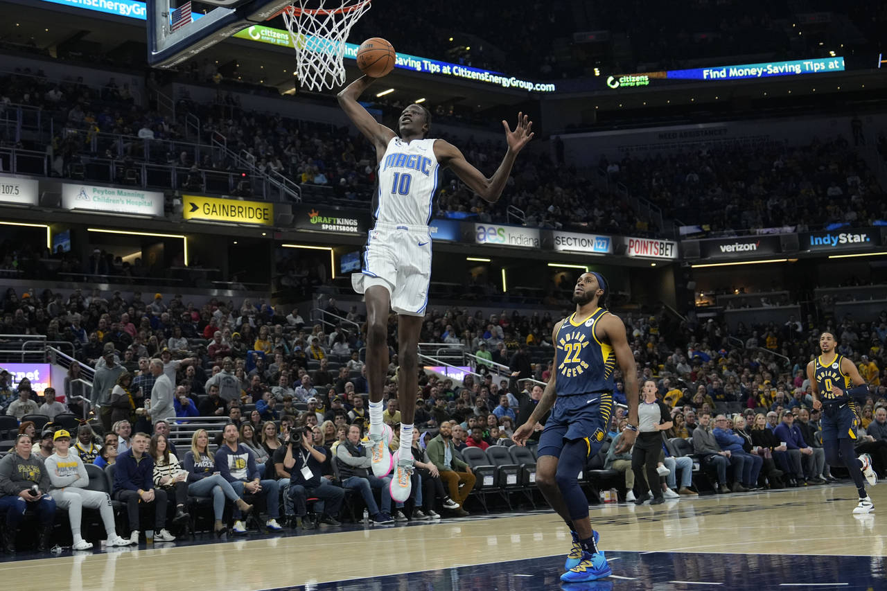Orlando Magic center Bol Bol (10) goes up to dunk in front of Indiana Pacers forward Isaiah Jackson...
