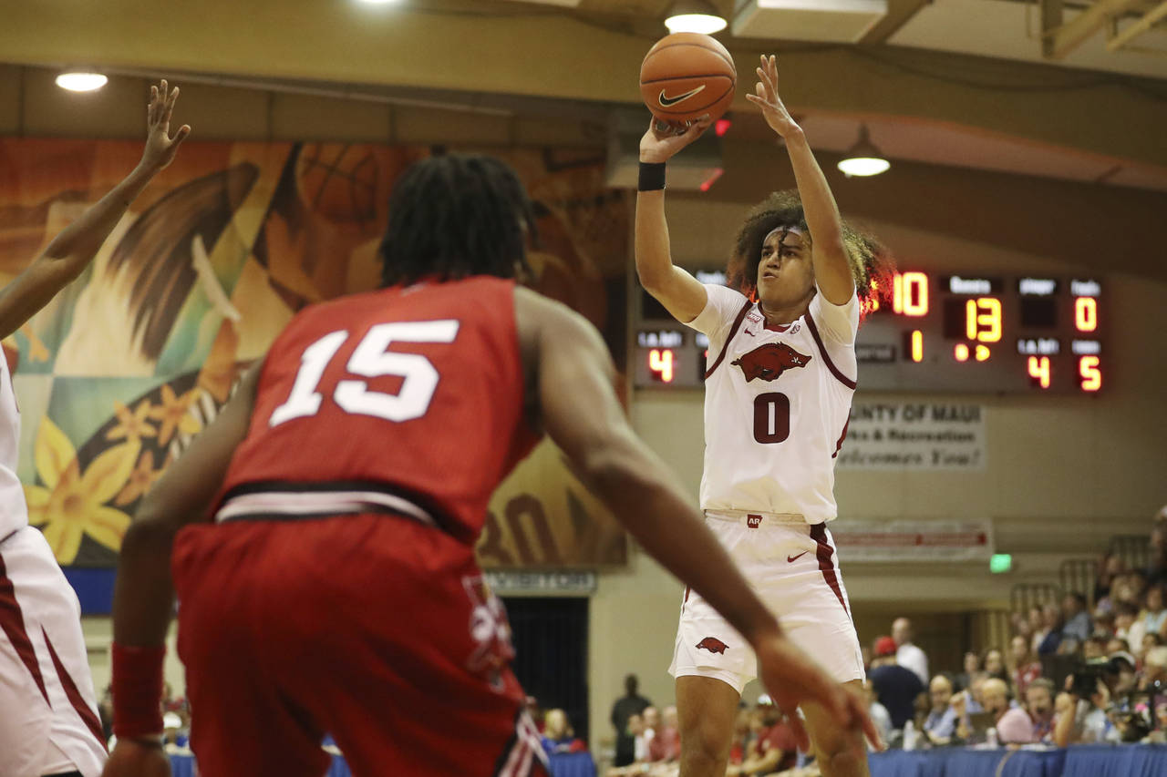 Arkansas guard Anthony Black (0) makes a shot over Louisville during the first half of an NCAA coll...