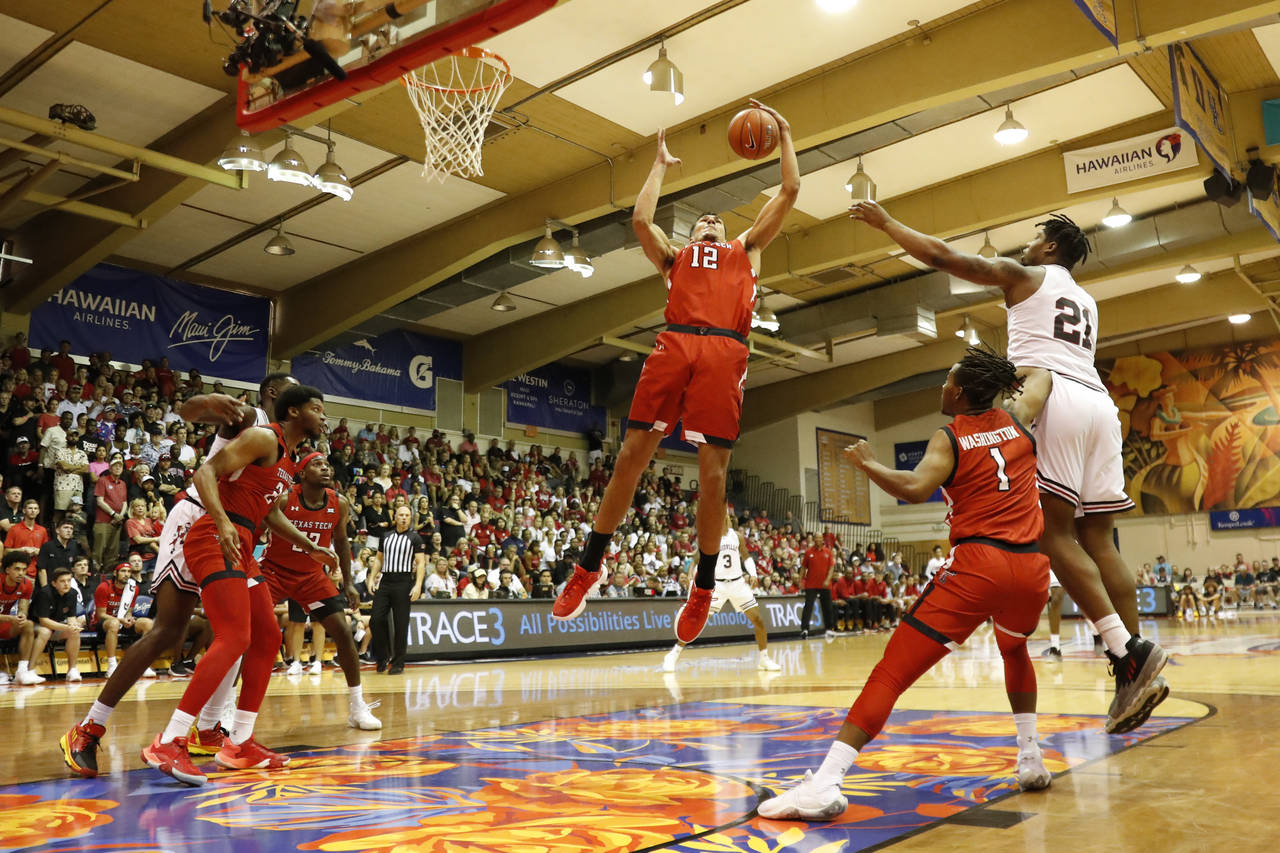 Texas Tech forward Daniel Batcho (12) grabs a rebound against Louisville during the first half of a...