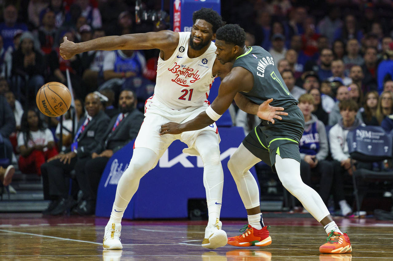 Minnesota Timberwolves' Anthony Edwards, right, knocks the ball away from Philadelphia 76ers' Joel ...
