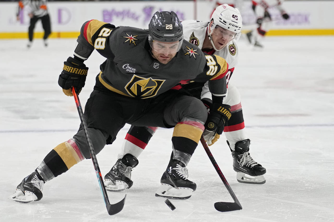 Vegas Golden Knights left wing William Carrier (28) battles for the puck with Ottawa Senators left ...