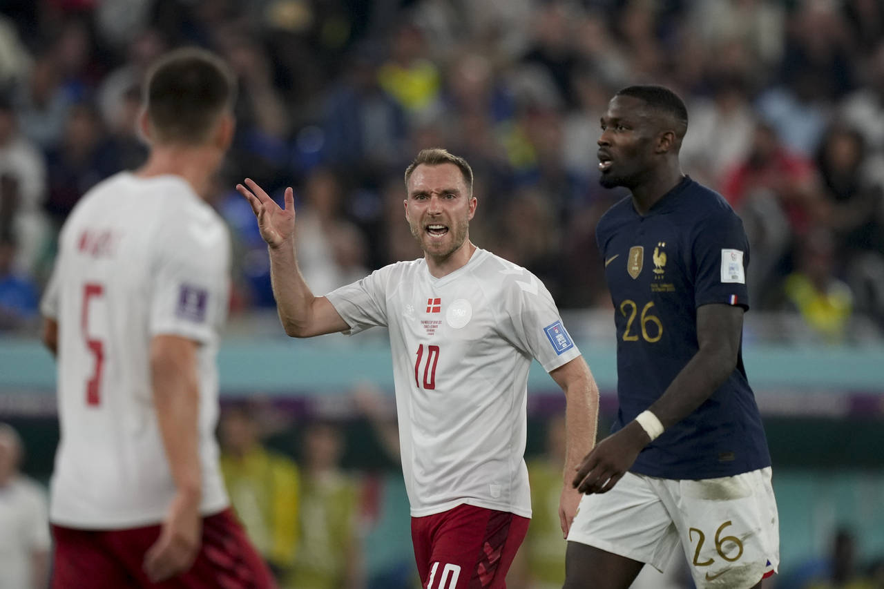 Denmark's Christian Eriksen, center, reacts during the World Cup group D soccer match between Franc...