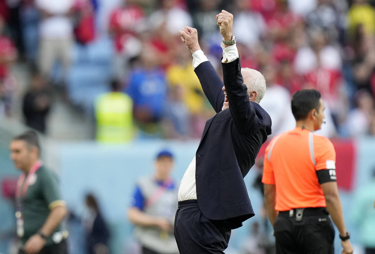 Australia's head coach Graham Arnold celebrates after winning the World Cup group D soccer match be...