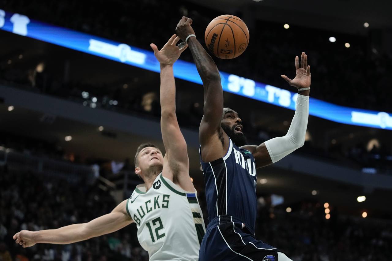 Milwaukee Bucks' Grayson Allen knocks the ball from Dallas Mavericks' Tim Hardaway Jr. during the f...