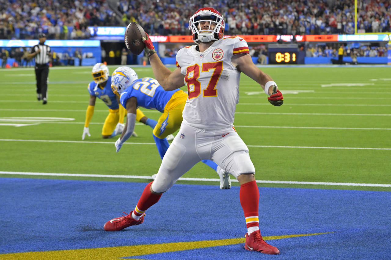 Kansas City Chiefs tight end Travis Kelce, right, celebrates a touchdown as Los Angeles Chargers sa...