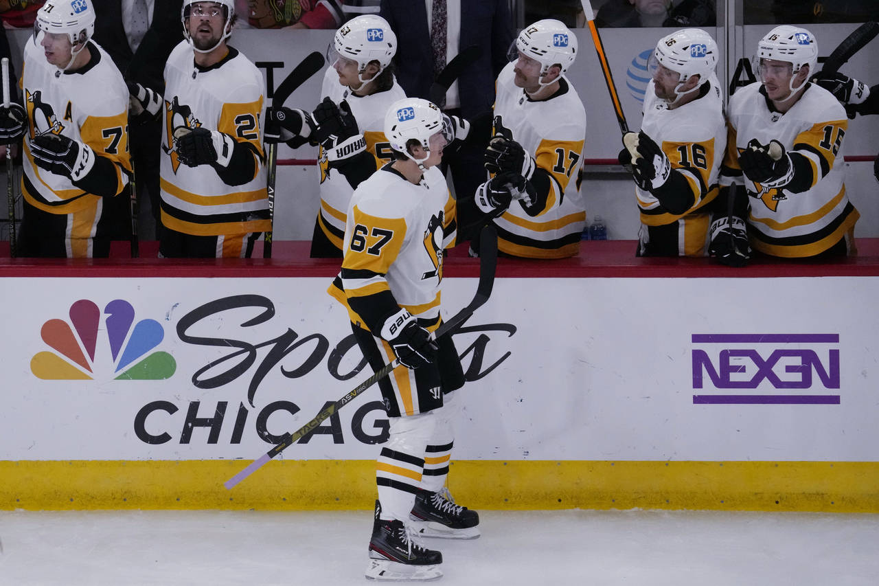 Pittsburgh Penguins right wing Rickard Rakell (67) celebrates with teammates after scoring a goal d...