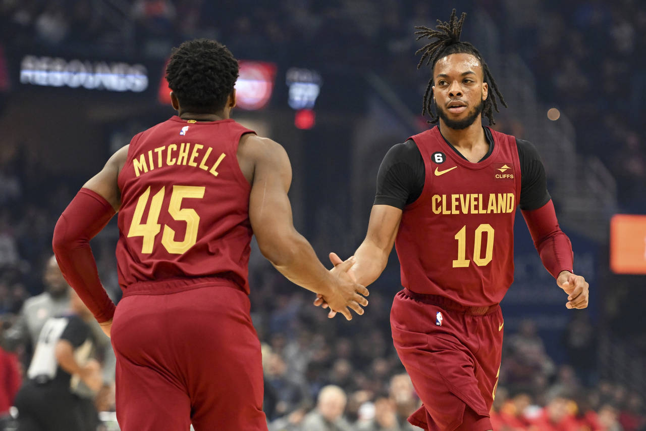 Cleveland Cavaliers guards Donovan Mitchell (45) and Darius Garland (10) celebrate a basket by Garl...
