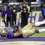 
              Washington running back Wayne Taulapapa (21) tumbles into the end zone for a touchdown against Oregon State during the second half of an NCAA collage football game Friday, Nov. 4, 2022, in Seattle. (AP Photo/John Froschauer)
            