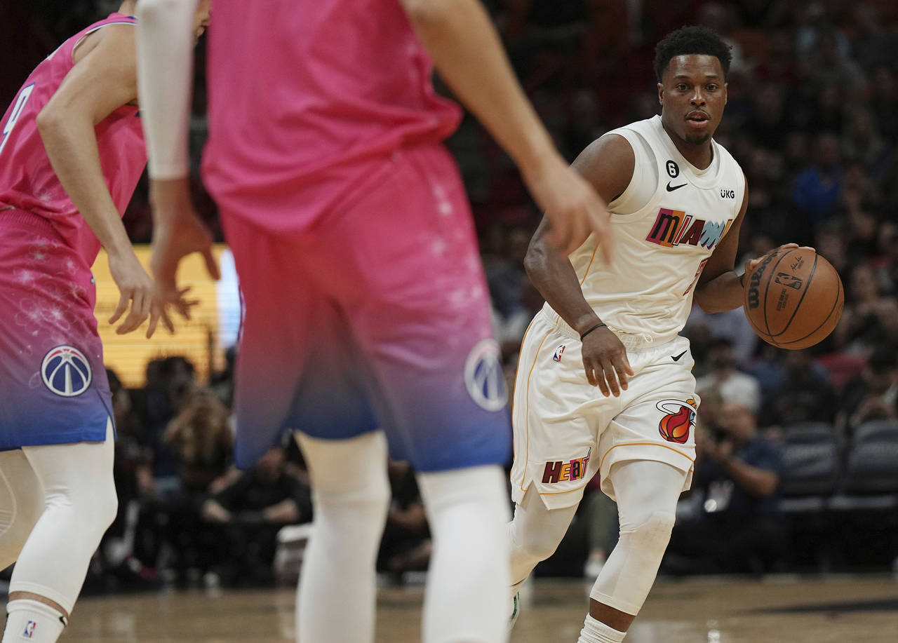 Miami Heat guard Kyle Lowry brings the ball up the court against the Washington Wizards during the ...