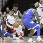 
              Gonzaga guard Malachi Smith (13) controls the ball while defended by Kentucky guard Sahvir Wheeler (2) during the first half of an NCAA college basketball game, Sunday, Nov. 20, 2022, in Spokane, Wash. (AP Photo/Young Kwak)
            