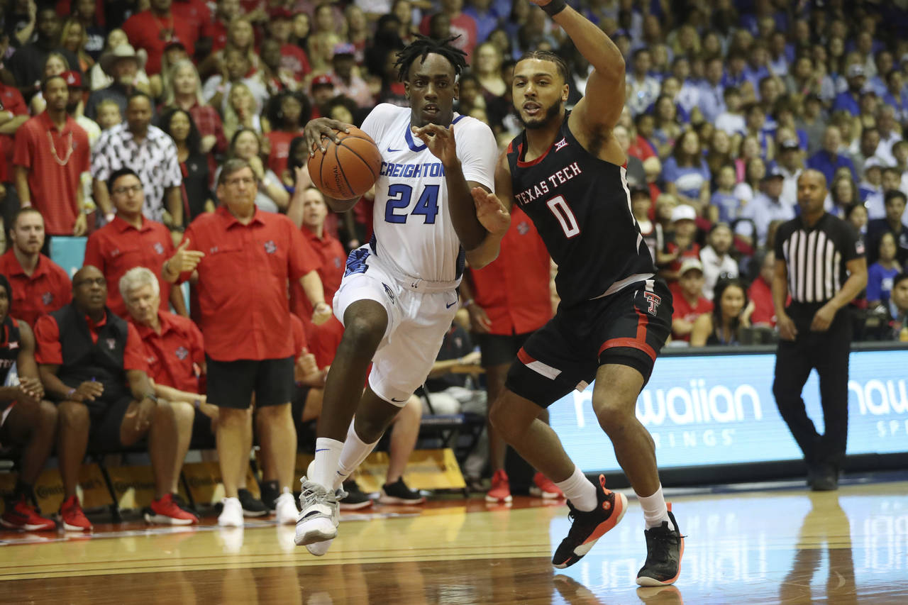 Creighton forward Arthur Kaluma (24) tries to get around Texas Tech forward Kevin Obanor (0) during...