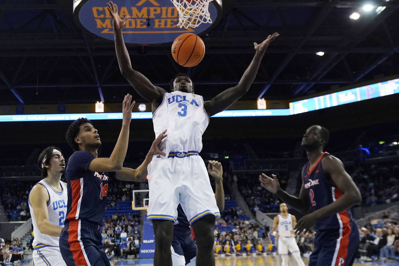 UCLA forward Adem Bona (3) grabs a rebound against Pepperdine during the first half of an NCAA coll...