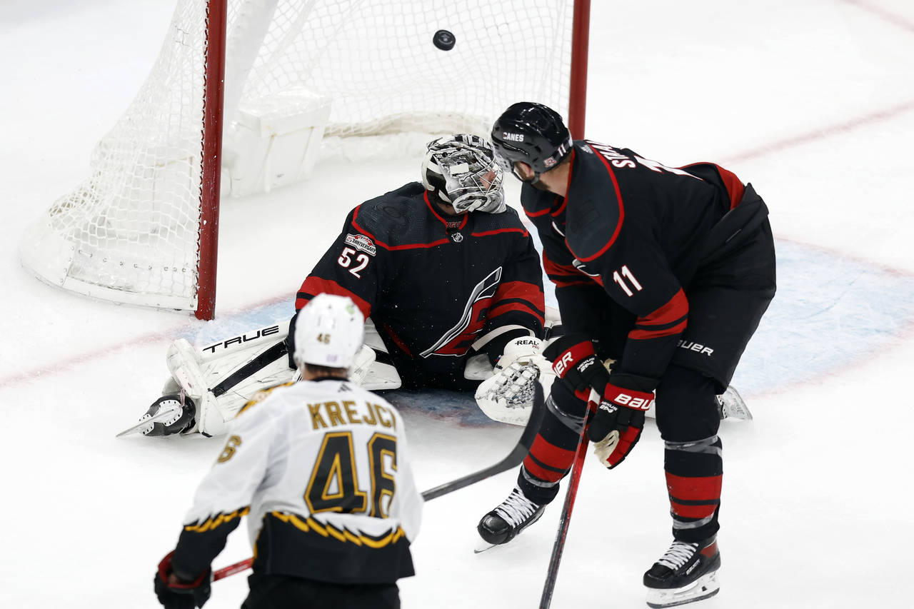 Boston Bruins' David Krejci (46) scores on Carolina Hurricanes' Pyotr Kochetkov (52) during the sec...