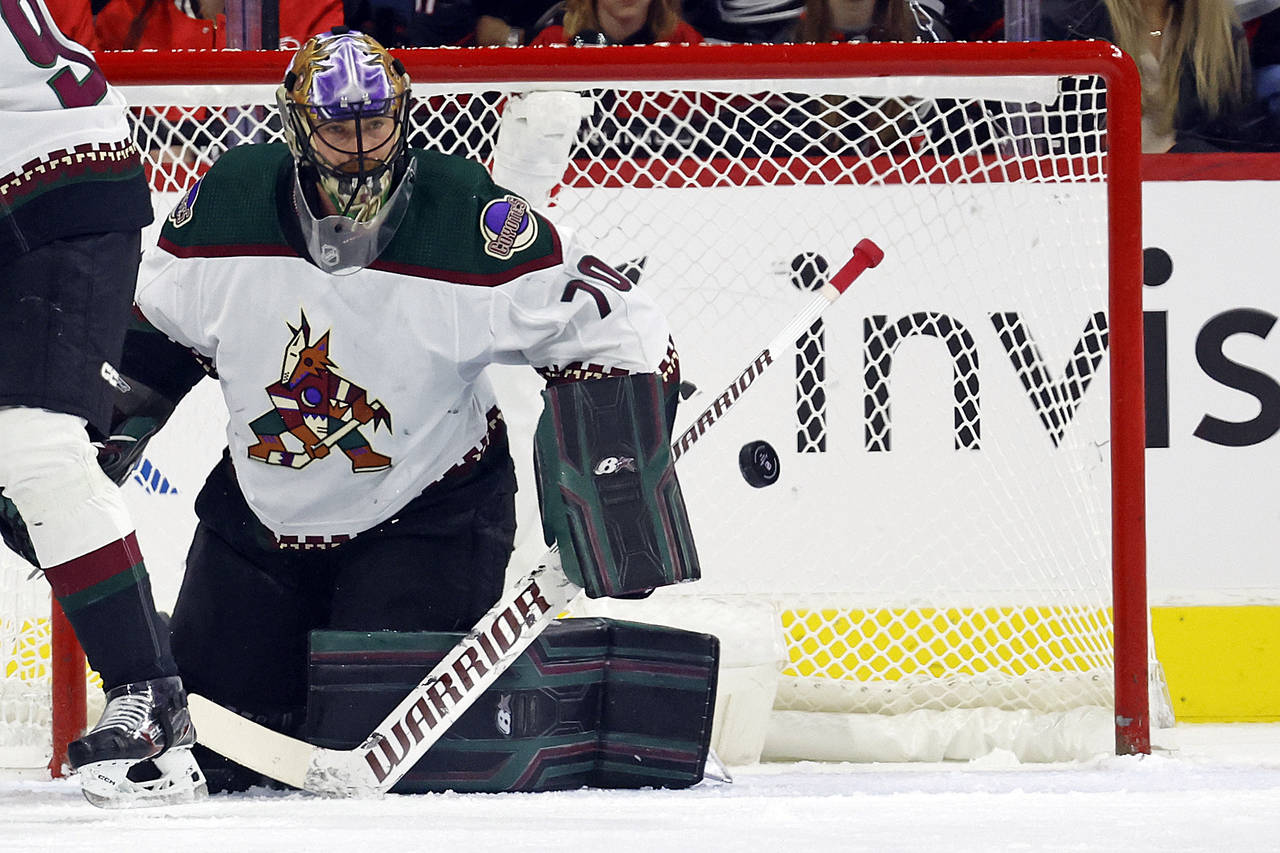Arizona Coyotes goaltender Karel Vejmelka (70) watches the puck during the first period of an NHL h...