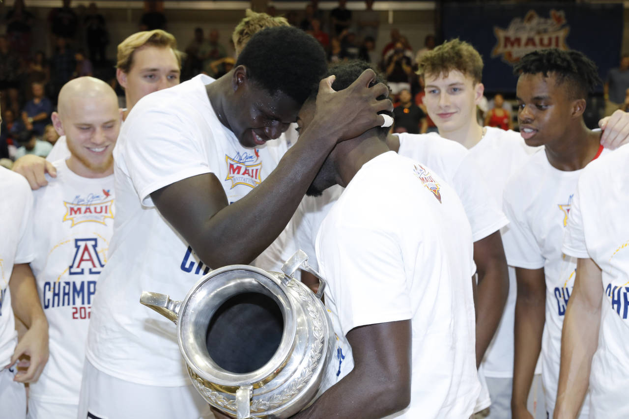 Arizona center Oumar Ballo front left, and guard Courtney Ramey celebrate after Arizona defeaed Cre...