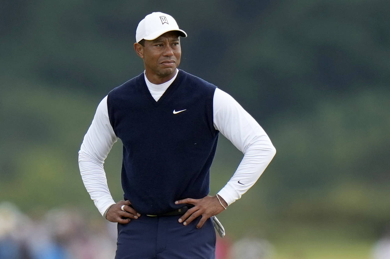 FILE - Tiger Woods, of the United States, stands on the 11th hole during the first round of the Bri...