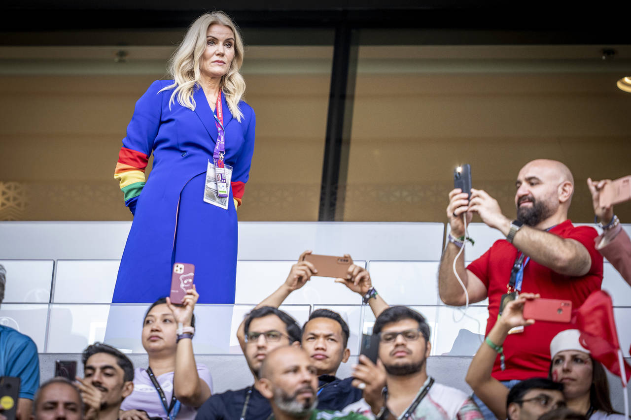 Former Danish Prime Minister Helle Thorning-Schmidt, left, wears a rainbow-colored armband before a...