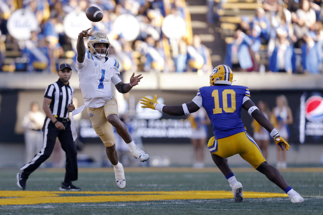 UCLA quarterback Dorian Thompson-Robinson (1) throws a pass as California linebacker Oluwafemi Olad...