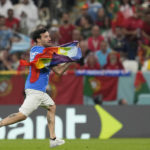 Protestor with rainbow flag runs onto field at World Cup