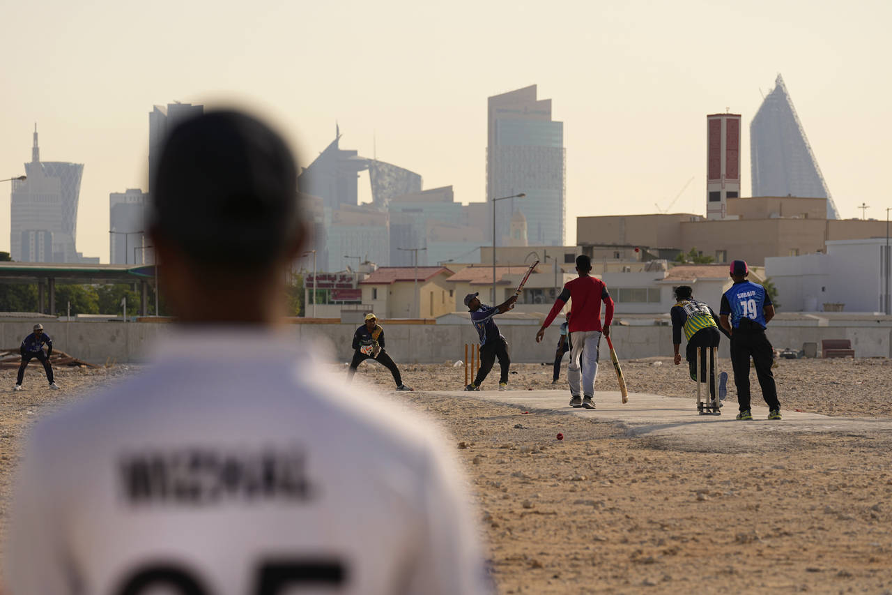 People play cricket in the streets in Doha, Qatar, Friday, Nov. 25, 2022. As dawn broke Friday as Q...