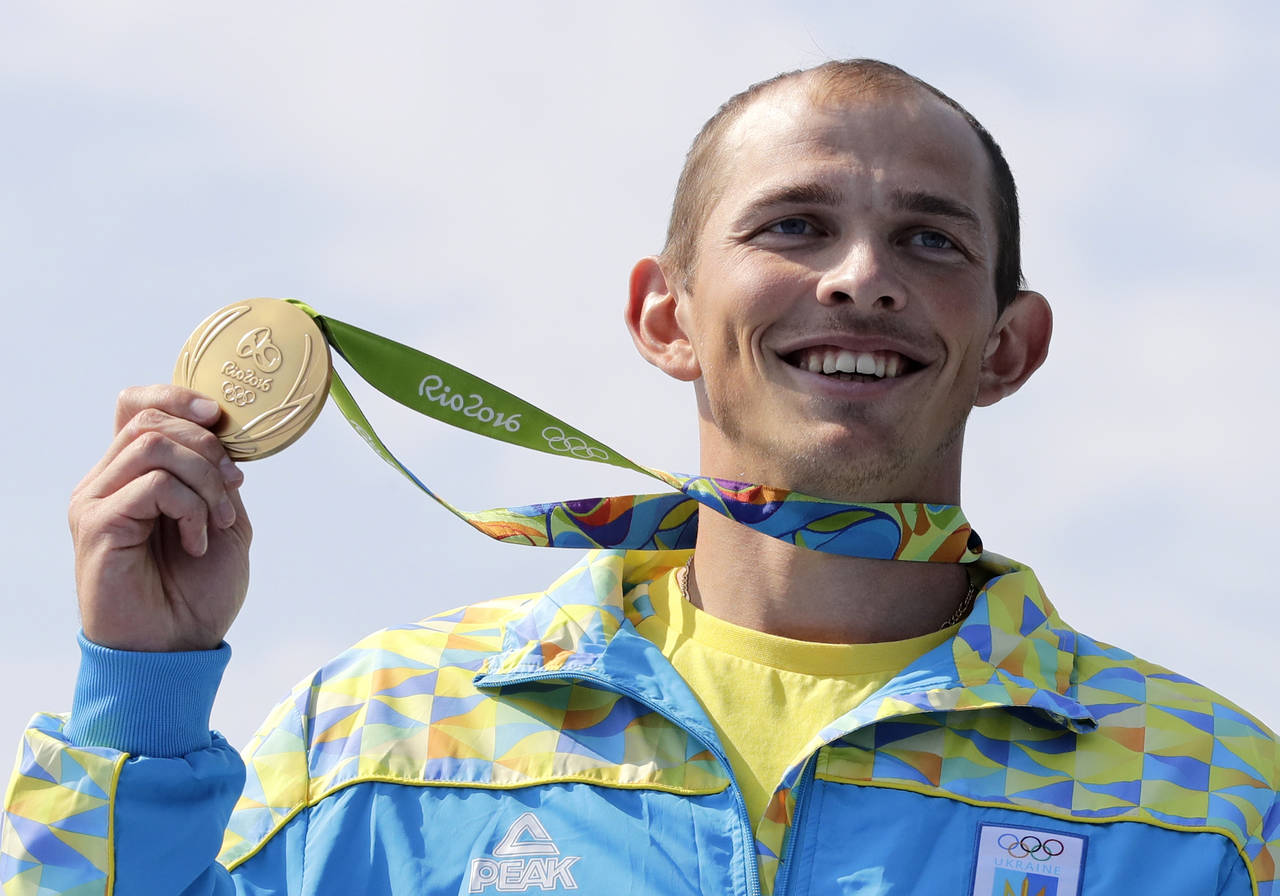 FILE - Ukraine's Yuri Cheban celebrates his gold medal in the men's canoe single 200m final during ...