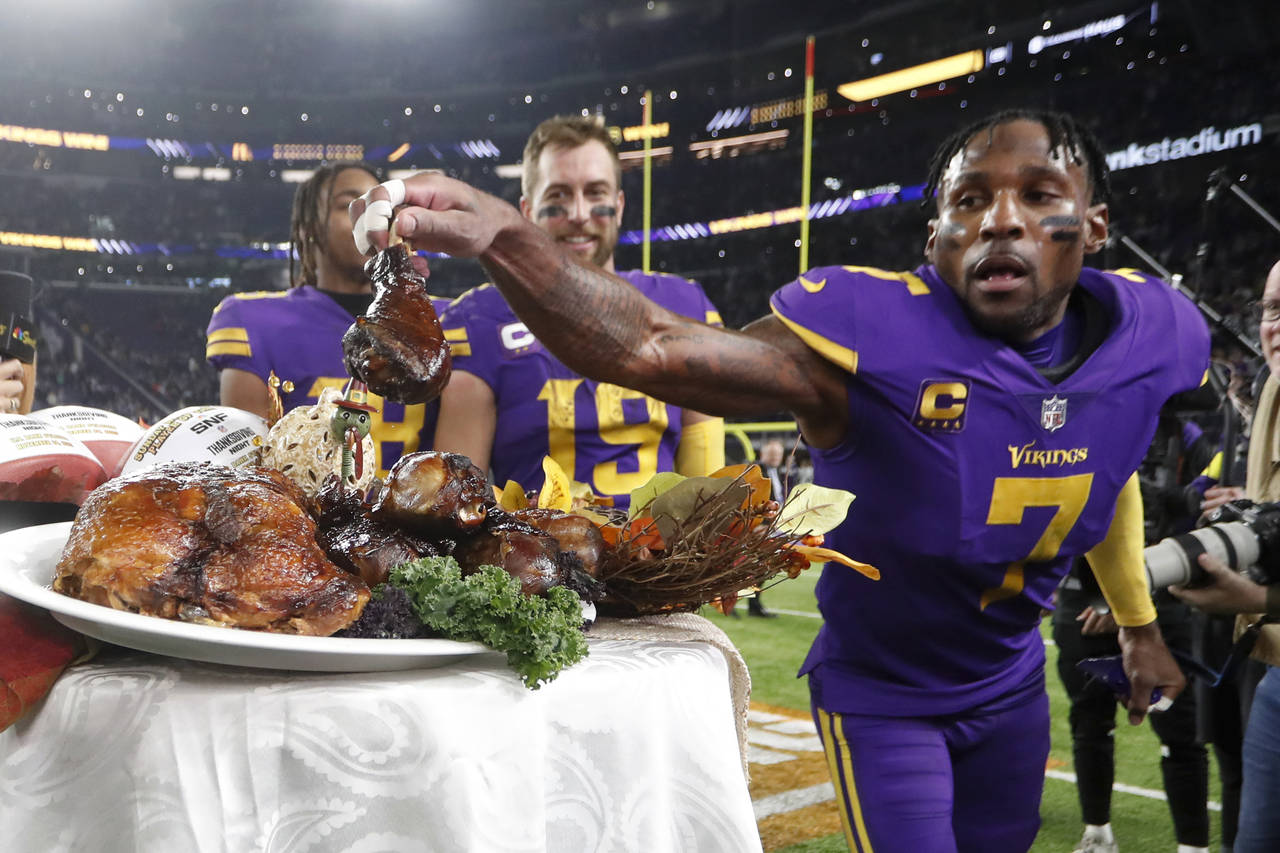 Minnesota Vikings cornerback Patrick Peterson (7) grabs a turkey leg off a plate before being inter...