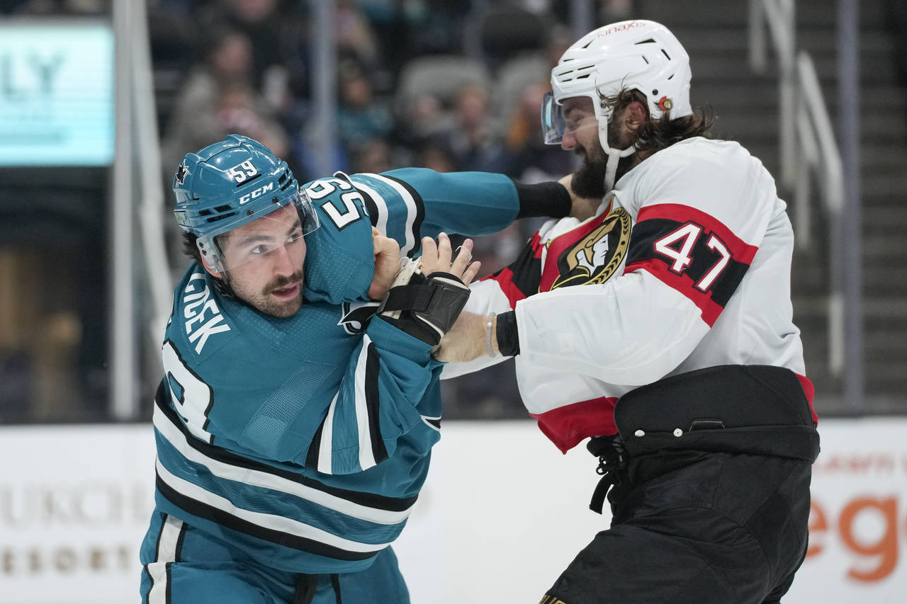 Ottawa Senators center Mark Kastelic (47) punches San Jose Sharks defenseman Nick Cicek during the ...