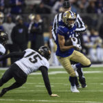 
              Washington wide receiver Jalen McMillan runs after making a catch, against Colorado linebacker Mister Williams, left, and defensive back Simeon Harris during the first half of an NCAA college football game, Saturday, Nov. 19, 2022, in Seattle. (AP Photo/Stephen Brashear)
            