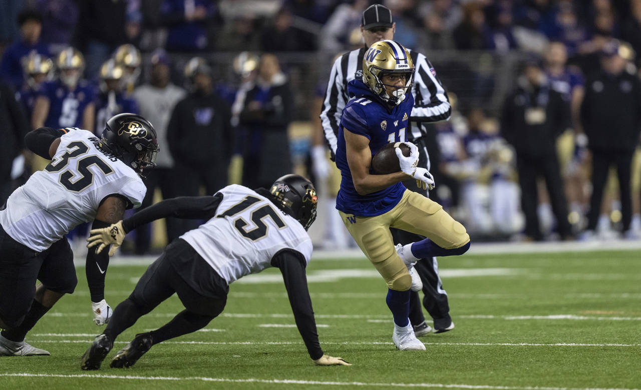 Washington wide receiver Jalen McMillan runs after making a catch, against Colorado linebacker Mist...
