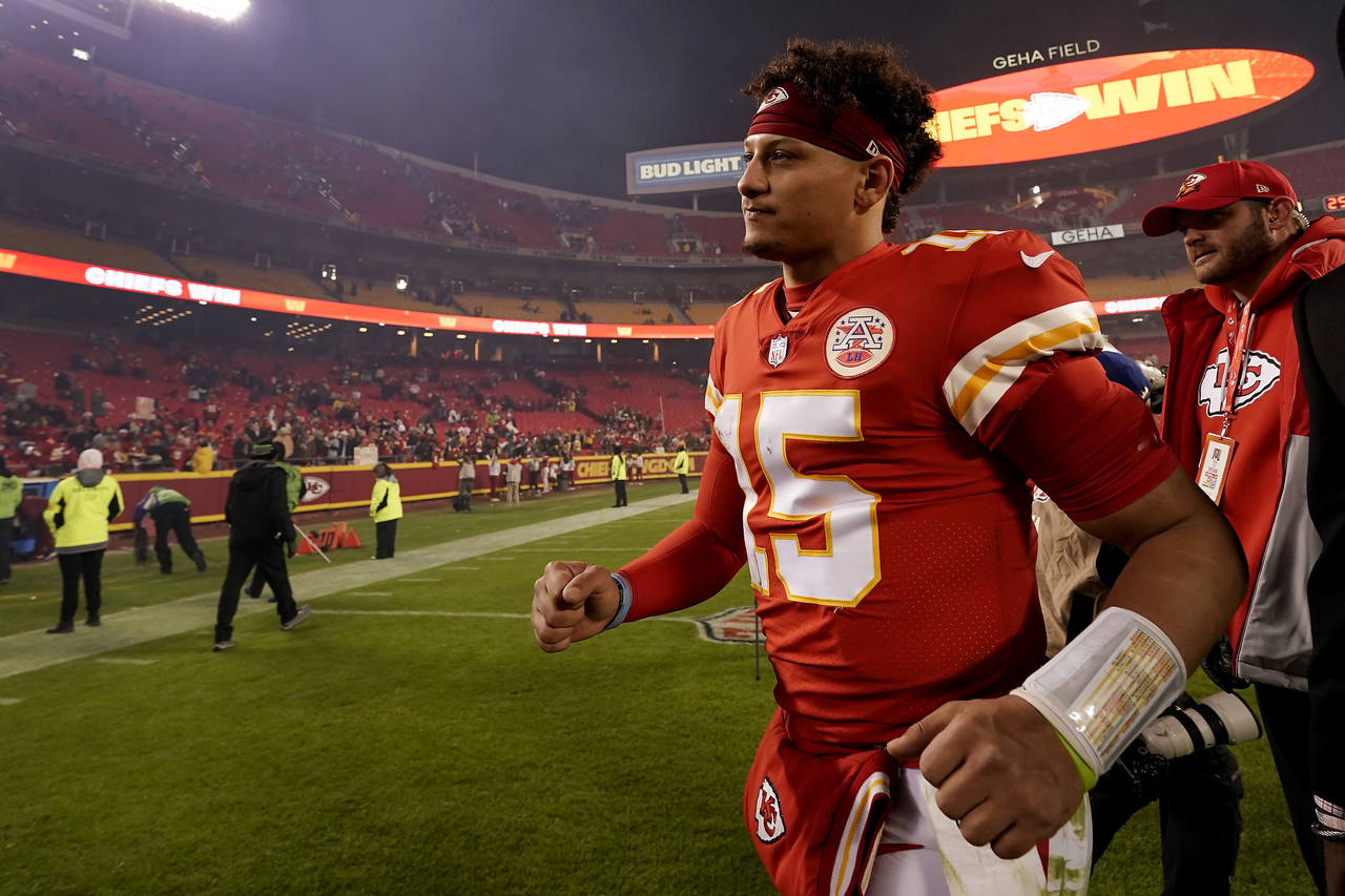 Kansas City Chiefs quarterback Patrick Mahomes runs off the field after an NFL football game agains...