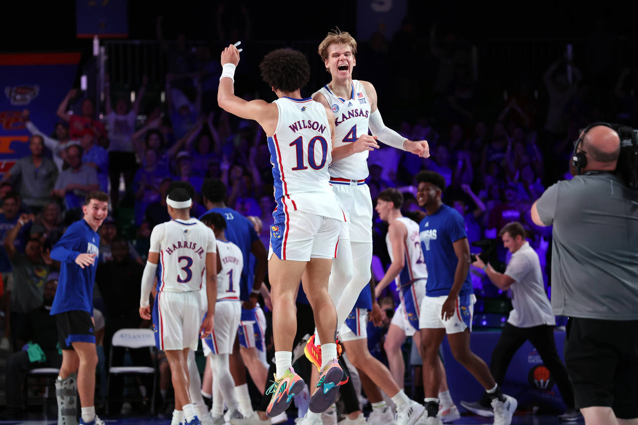 In a photo provided by Bahamas Visual Services, Kansas' Jalen Wilson (10) and Gradey Dick (4) celeb...