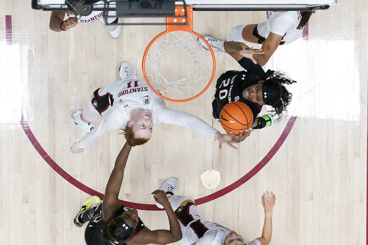 Stanford forward Ashten Prechtel (11) and South Carolina forward Sania Feagin (20) compete for a re...