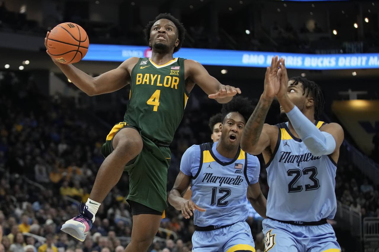 Baylor's LJ Cryer shoots past Marquette's David Joplin during the second half of an NCAA college ba...