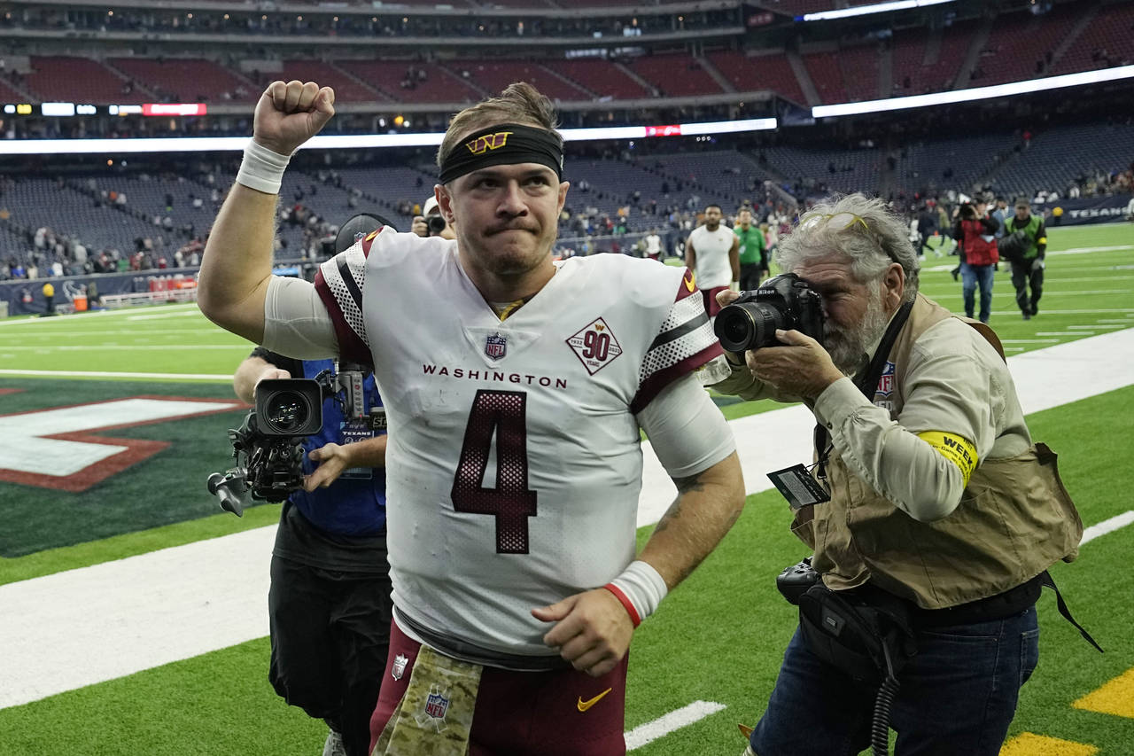 Washington Commanders quarterback Taylor Heinicke (4) runs off the field following the team's win o...