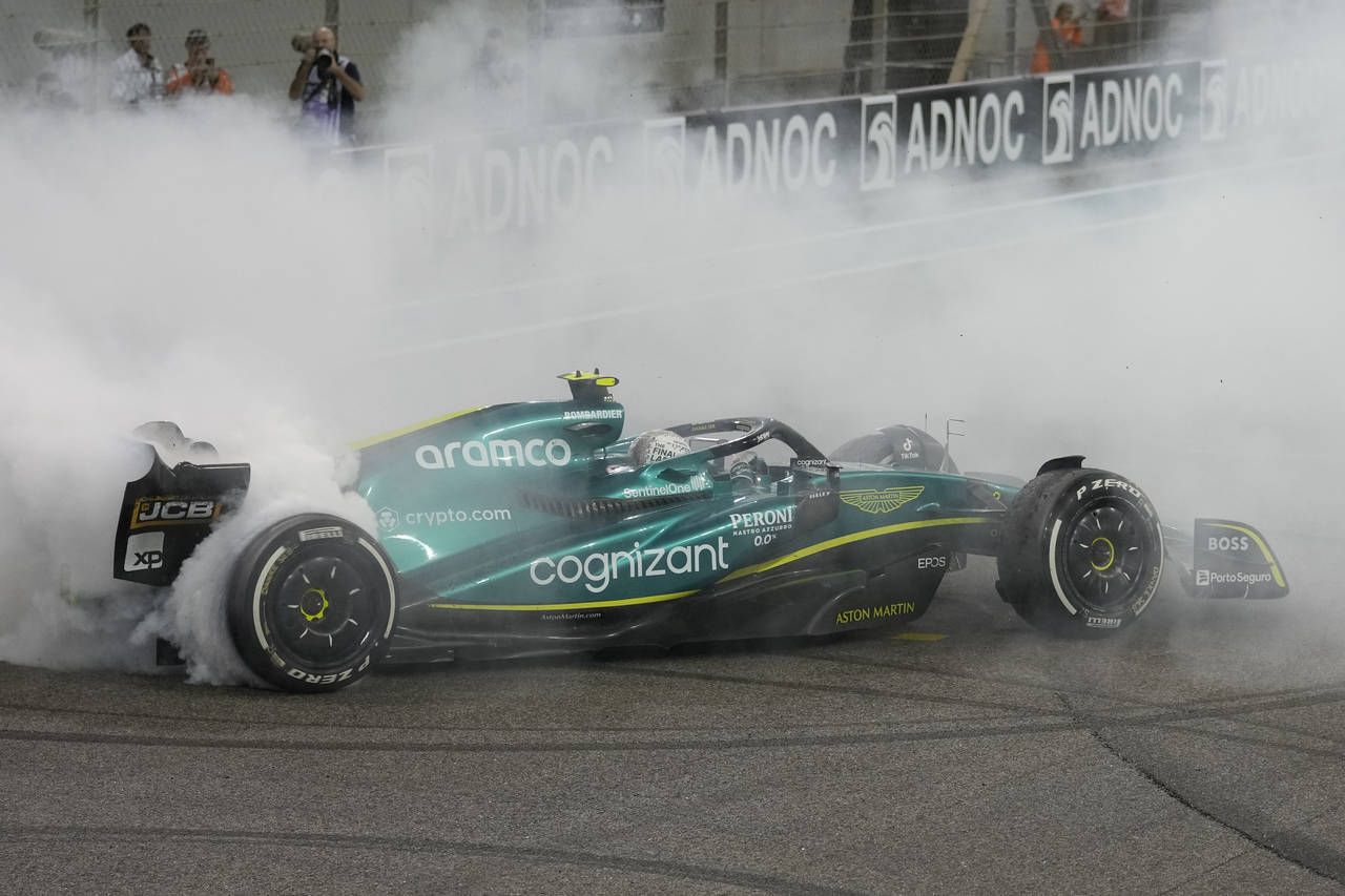 Aston Martin driver Sebastian Vettel of Germany burns the tires as he finished his last race in car...