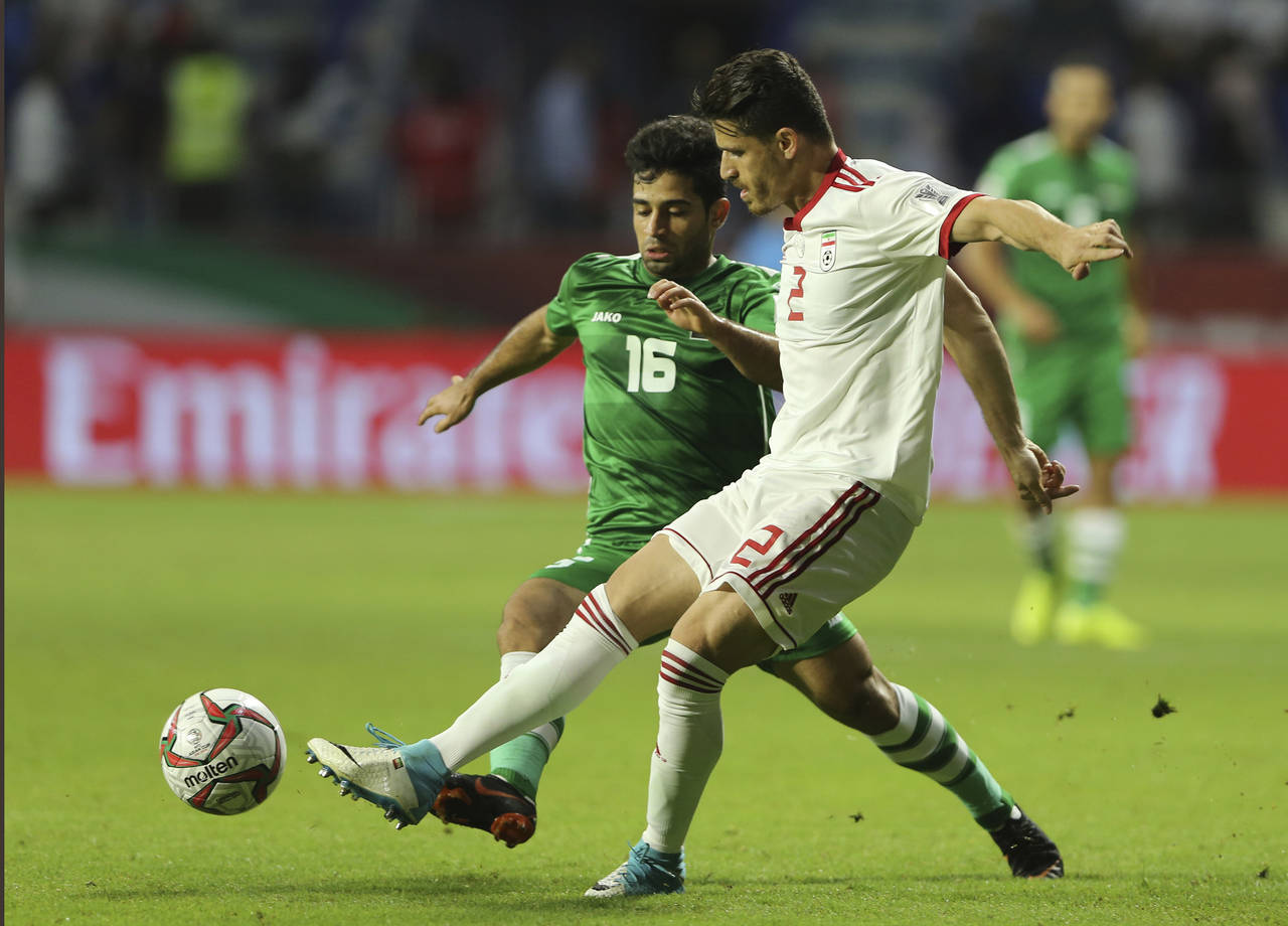FILE — Voria Ghafouri, right, fights for the ball with Iraqi midfielder Hussein Ali, during the A...