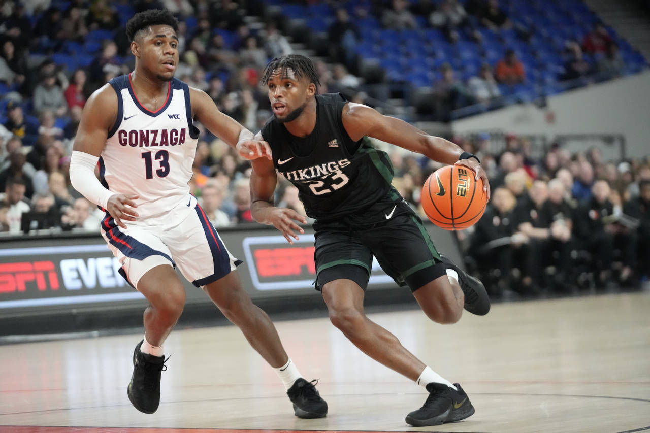 Portland State guard Jorell Saterfield (23) drives as Gonzaga guard Malachi Smith (13) defends duri...