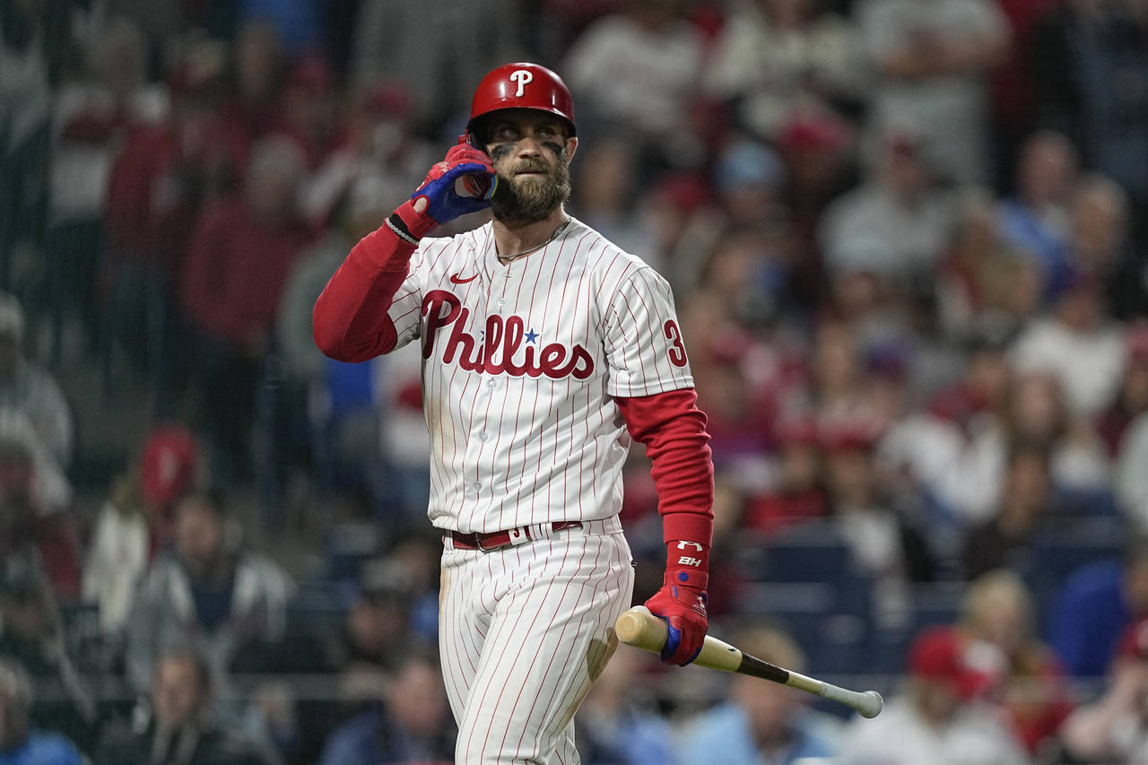 Philadelphia Phillies' Bryce Harper walks to the dugout after striking out during the fourth inning...